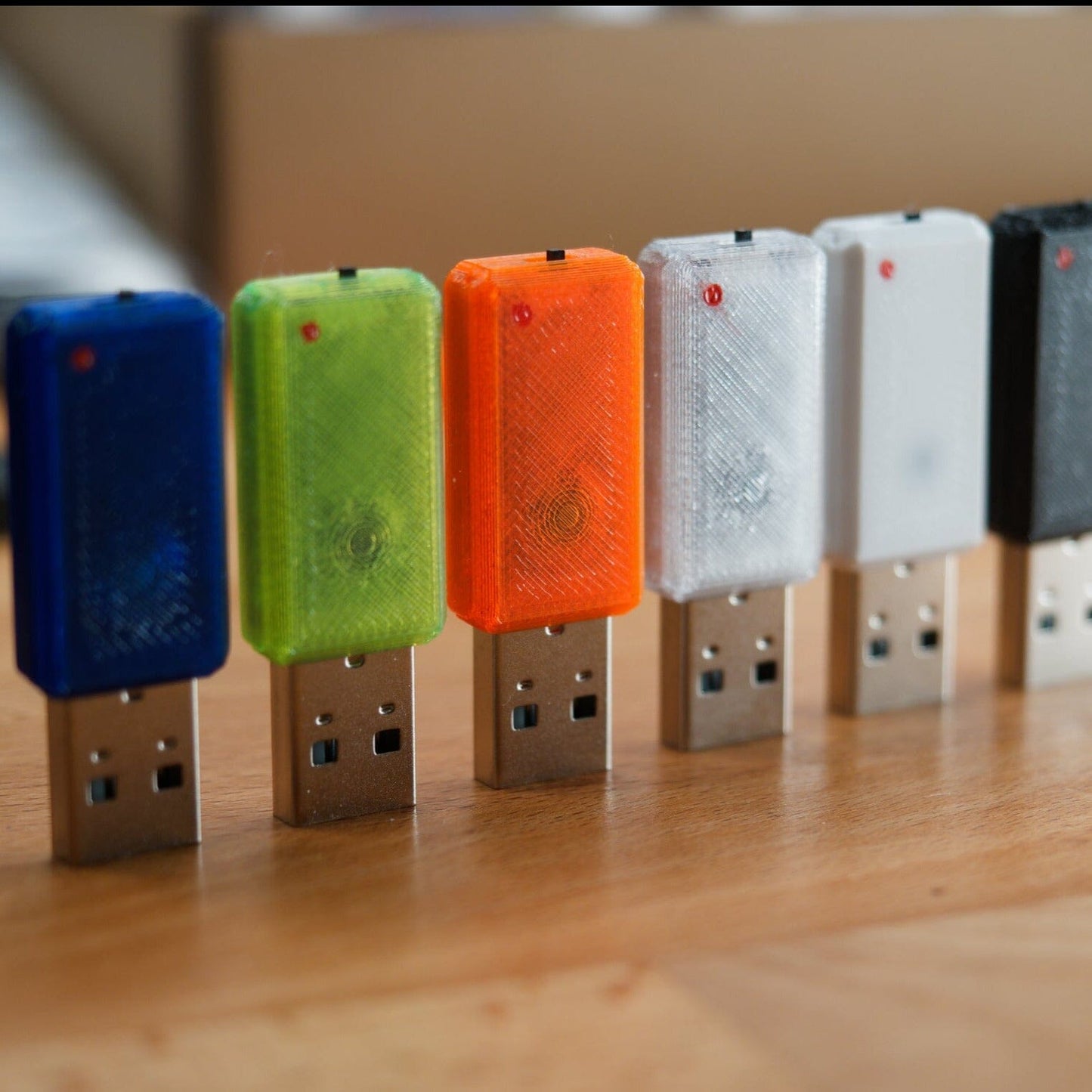 USB Novas with 6 different colored cases. In blue, green, orange, transparent, white, black.
