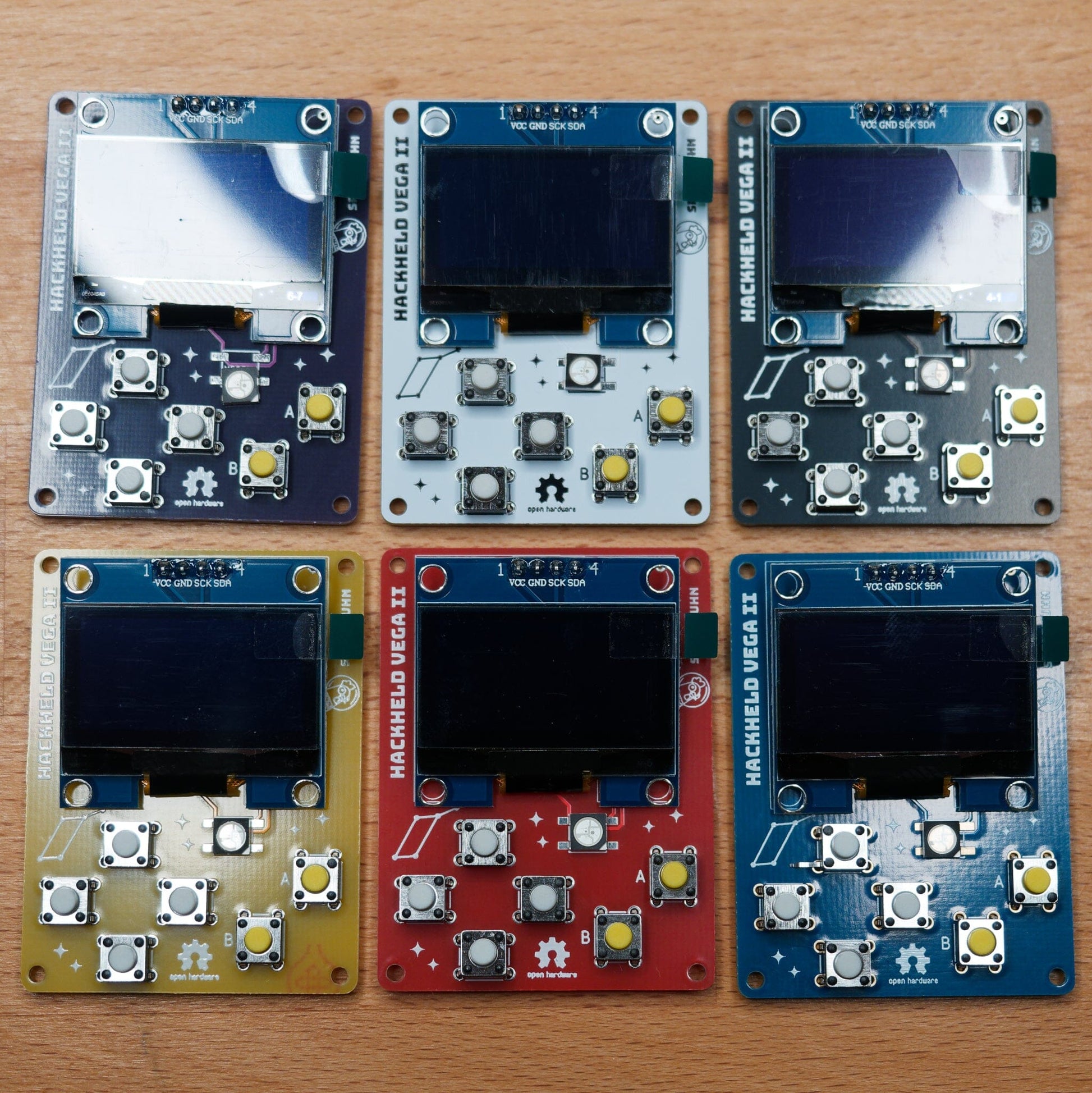 HackHeld Vega II PCBs in purple, white, black, yellow, red, blue with components