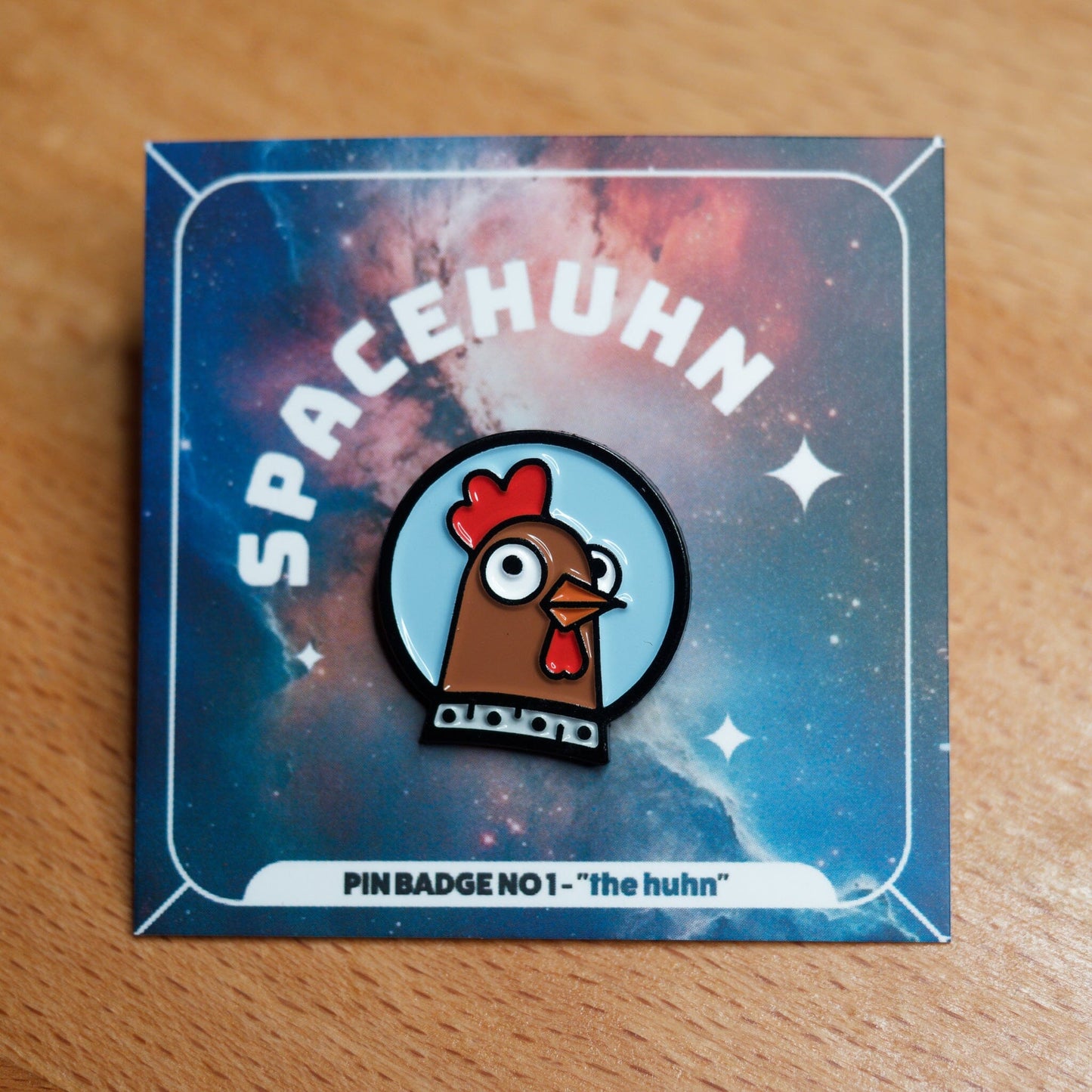 Spacehuhn Enamel Pin on card with space background